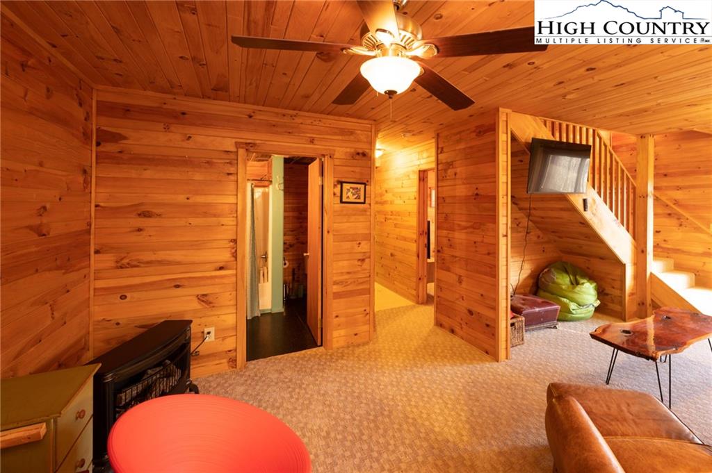 6218 Junaluska Road Boone, NC 28607 - Photo 23 of 33 a bedroom with a bed and a chandelier