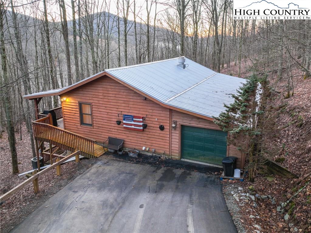 6218 Junaluska Road Boone, NC 28607 - Photo 3 of 33 a backyard of a house with wooden fence and trees