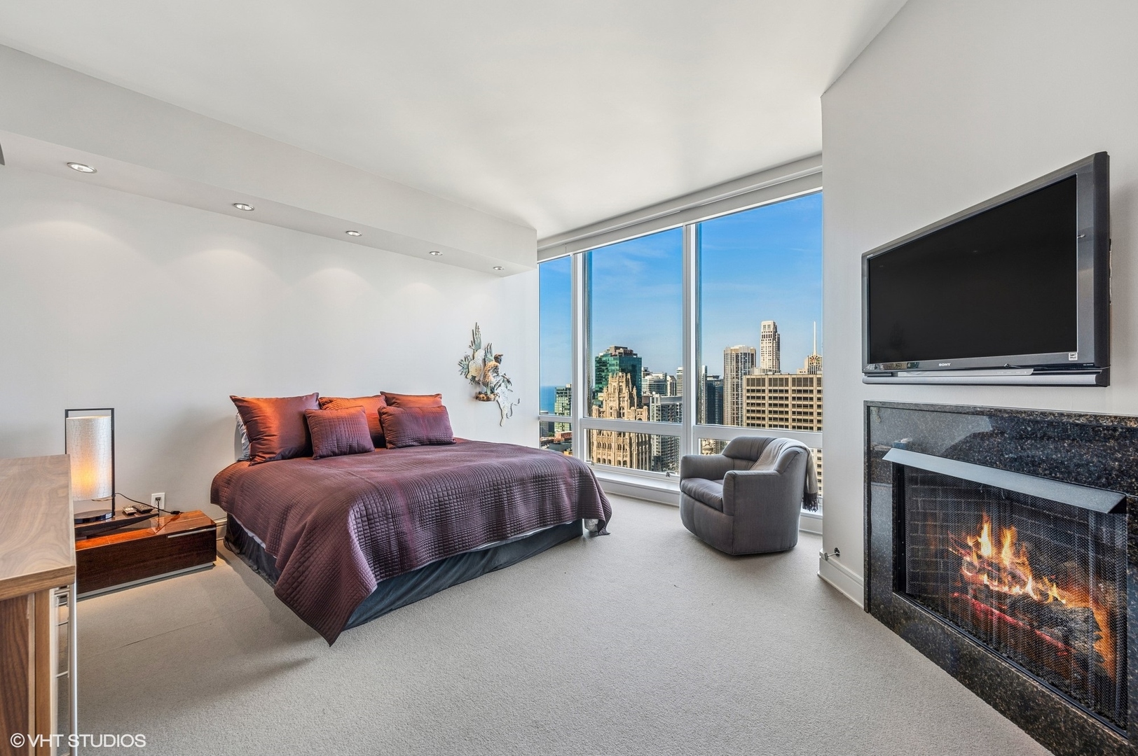 401 North Wabash Avenue, Unit 33K Chicago, IL 60611 - Photo 9 of 45 a bedroom with a bed and a fireplace