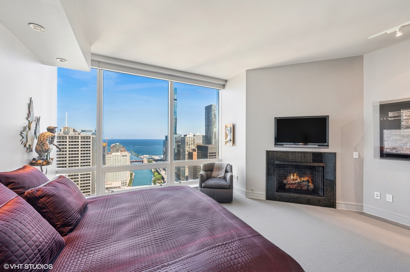 401 North Wabash Avenue, Unit 33K Chicago, IL 60611 - Photo 10 of 45 a bedroom with furniture and a fireplace