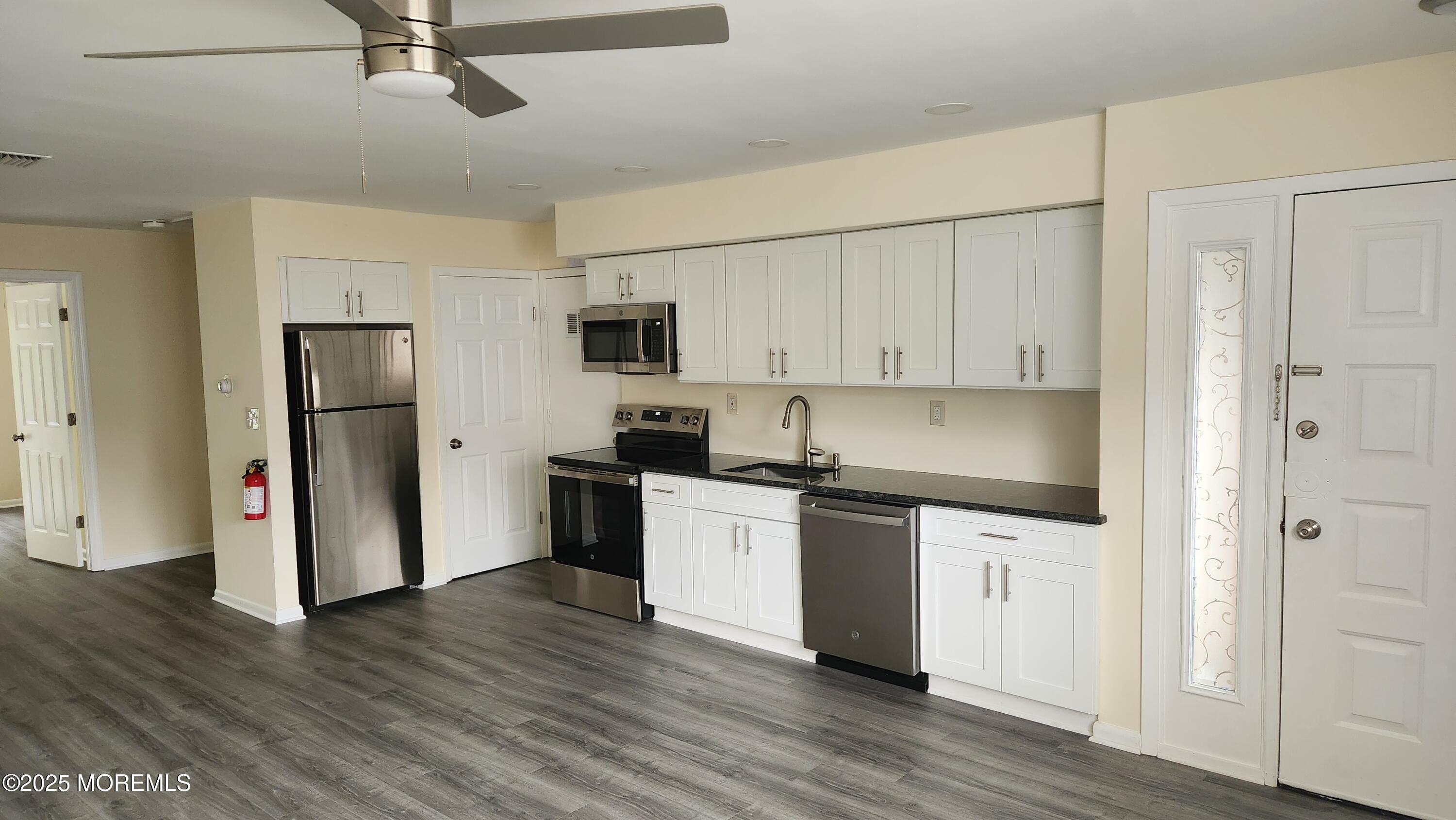 290 North Main Street, Unit B9 Barnegat, NJ 08005 - Photo 2 of 8 a kitchen with stainless steel appliances a sink cabinets and wooden floor