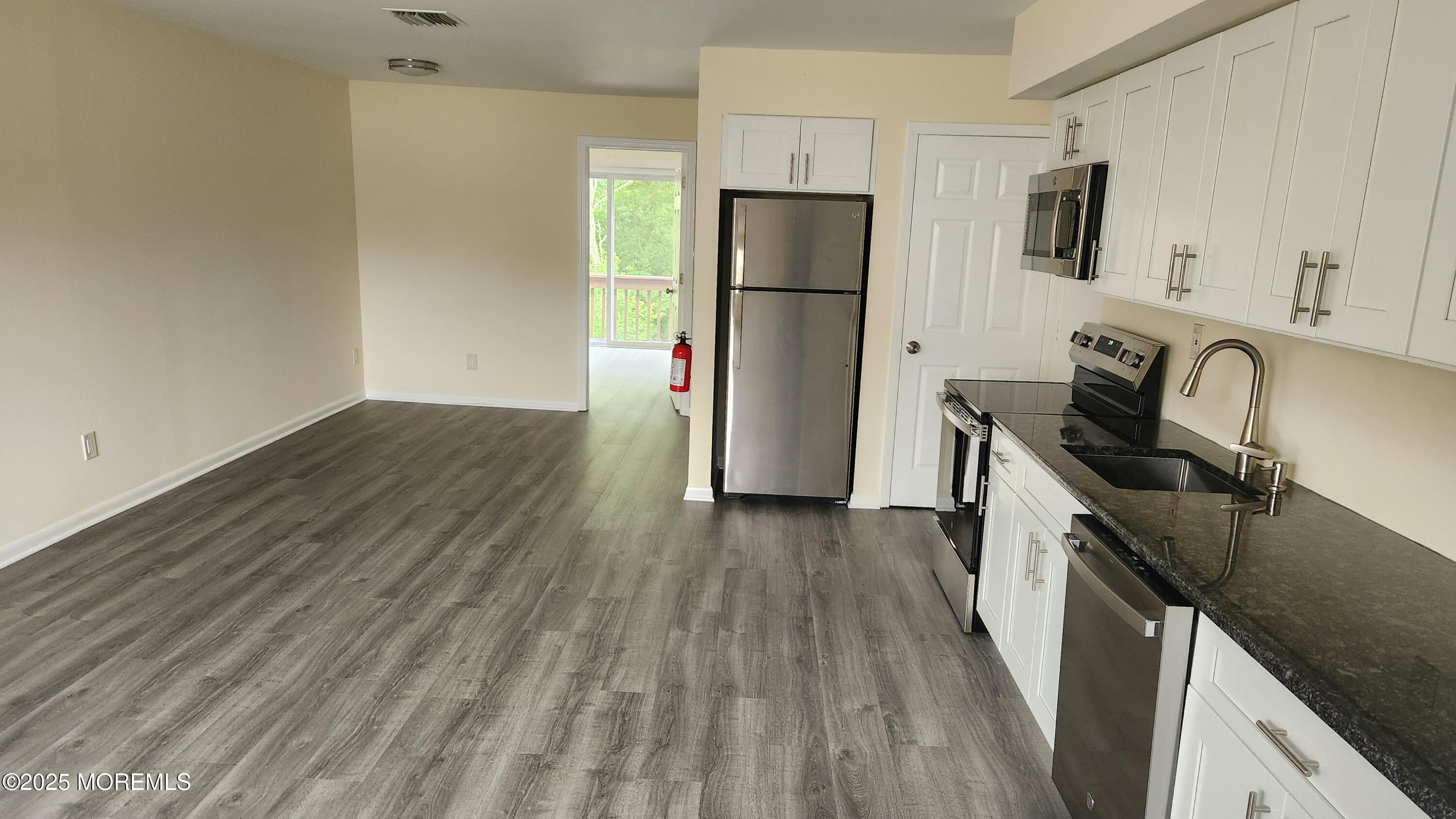 290 North Main Street, Unit B9 Barnegat, NJ 08005 - Photo 3 of 8 a kitchen with a sink a refrigerator and a stove top oven