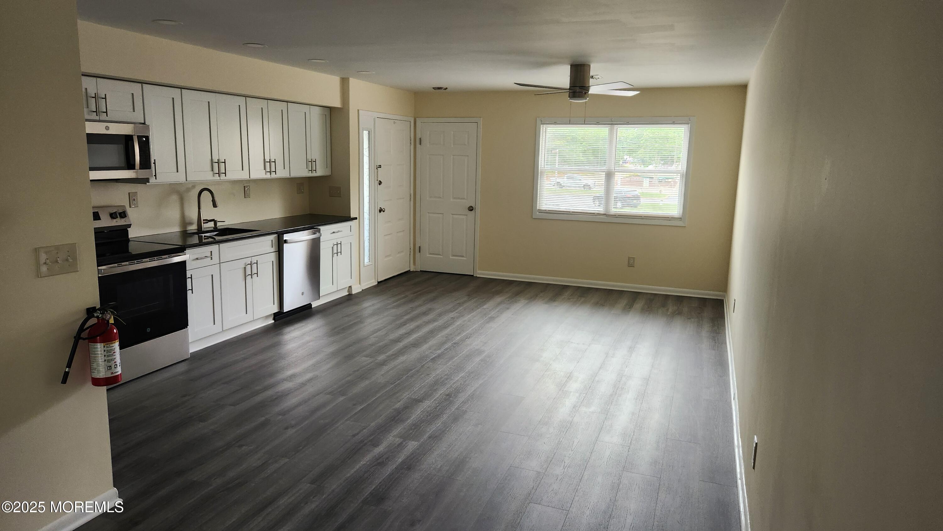 290 North Main Street, Unit B9 Barnegat, NJ 08005 - Photo 4 of 8 a kitchen with granite countertop wooden floors a sink and a window