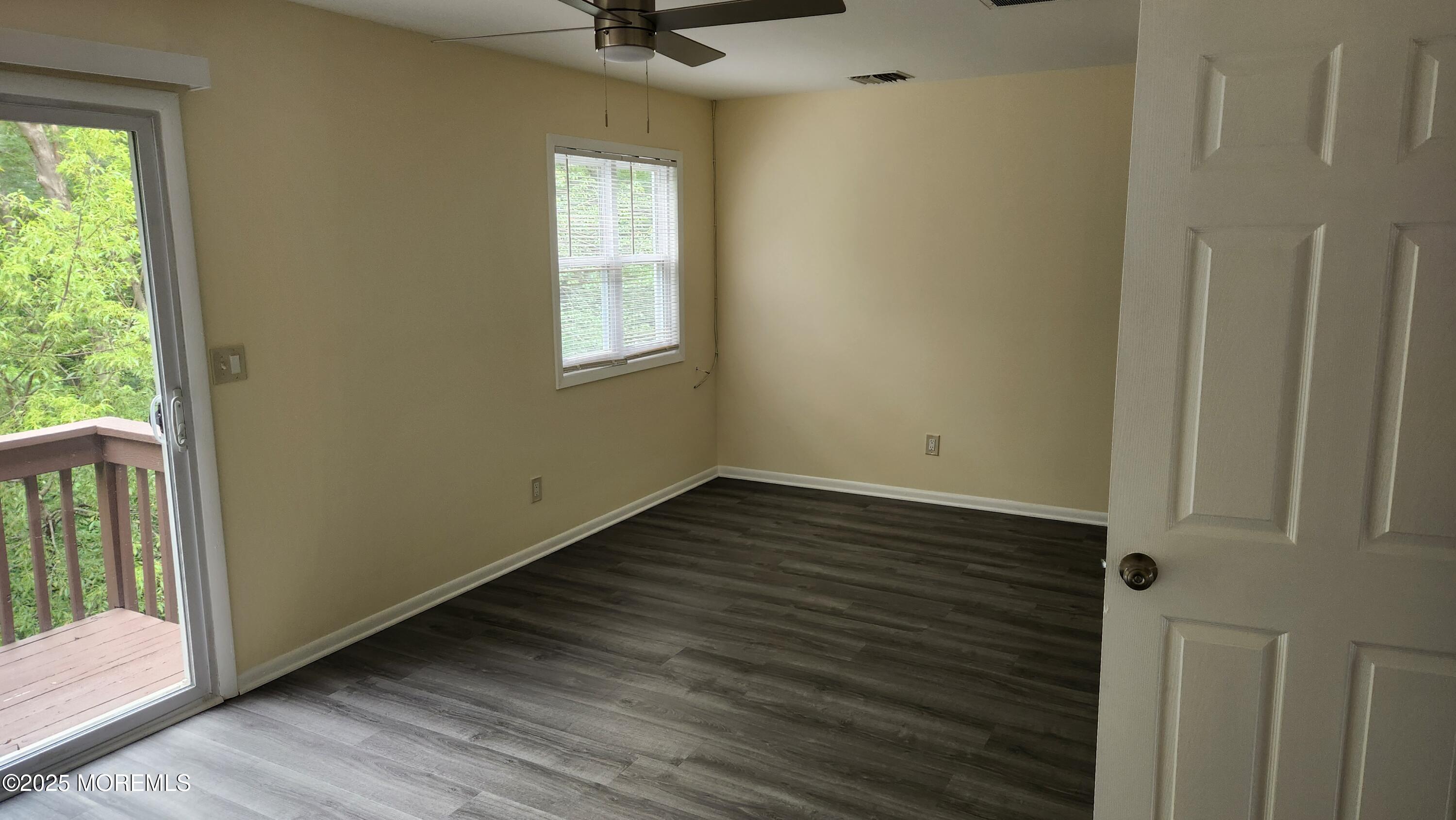 290 North Main Street, Unit B9 Barnegat, NJ 08005 - Photo 5 of 8 a view of an empty room with wooden floor and a window