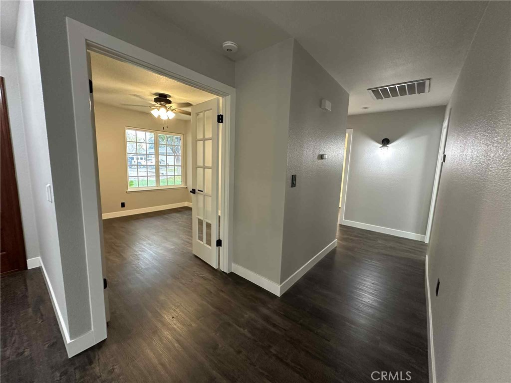 1939 Sierra Court Merced, CA 95340 - Photo 13 of 22 an empty room with wooden floor and windows