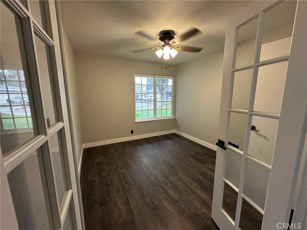 1939 Sierra Court Merced, CA 95340 - Photo 14 of 22 a view of an empty room with wooden floor and a window