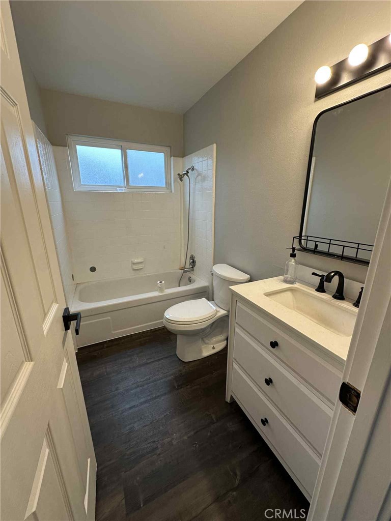 1939 Sierra Court Merced, CA 95340 - Photo 15 of 22 a bathroom with a double vanity sink toilet mirror and tub