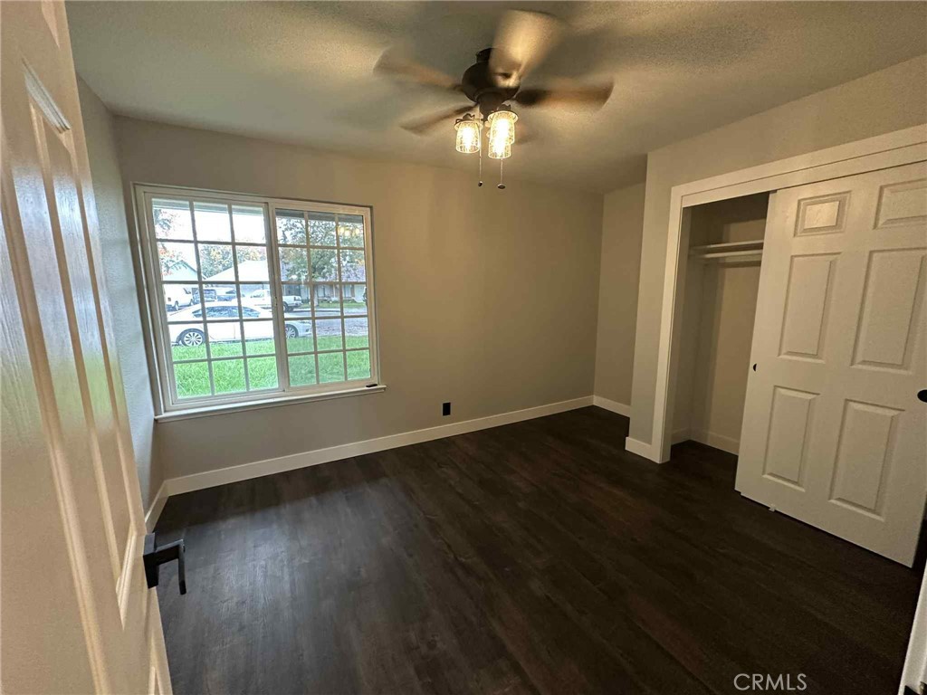 1939 Sierra Court Merced, CA 95340 - Photo 16 of 22 wooden floor in an empty room with a window