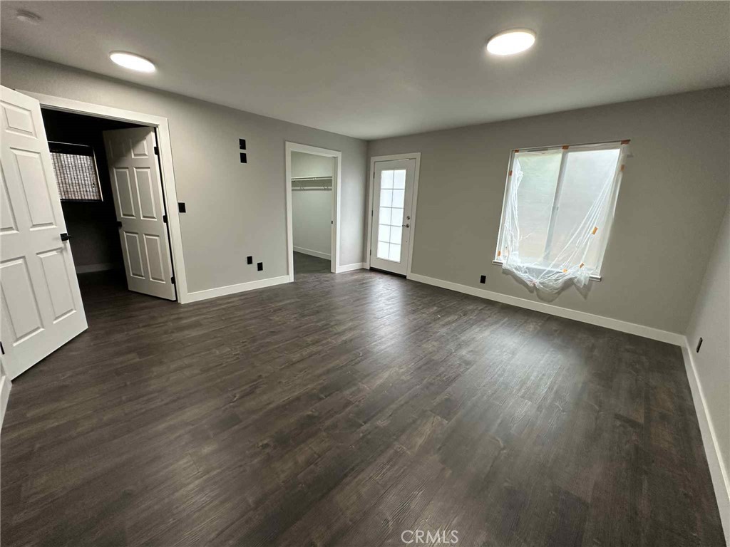 1939 Sierra Court Merced, CA 95340 - Photo 19 of 22 an empty room with wooden floor and windows