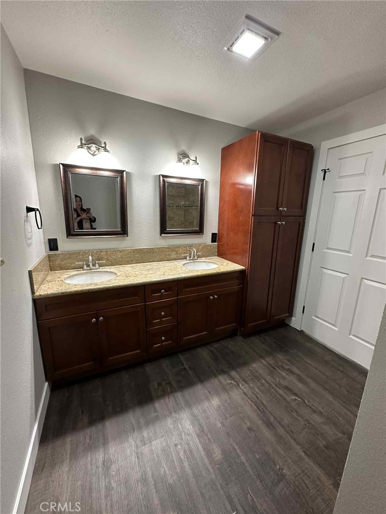 1939 Sierra Court Merced, CA 95340 - Photo 20 of 22 a spacious bathroom with double vanity and a mirror
