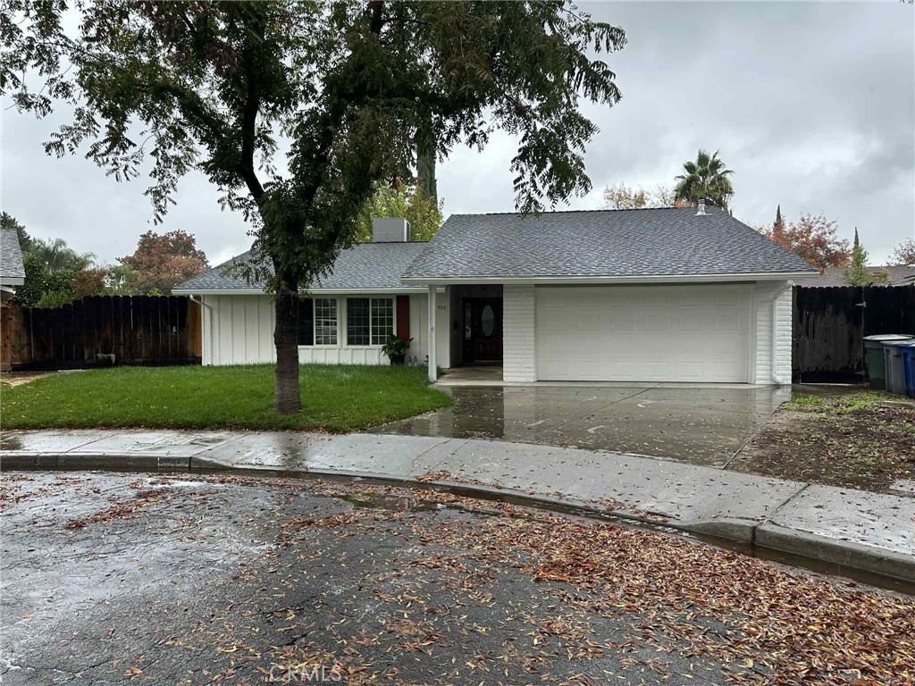 1939 Sierra Court Merced, CA 95340 - Photo 2 of 22 a front view of a house with a garden and trees