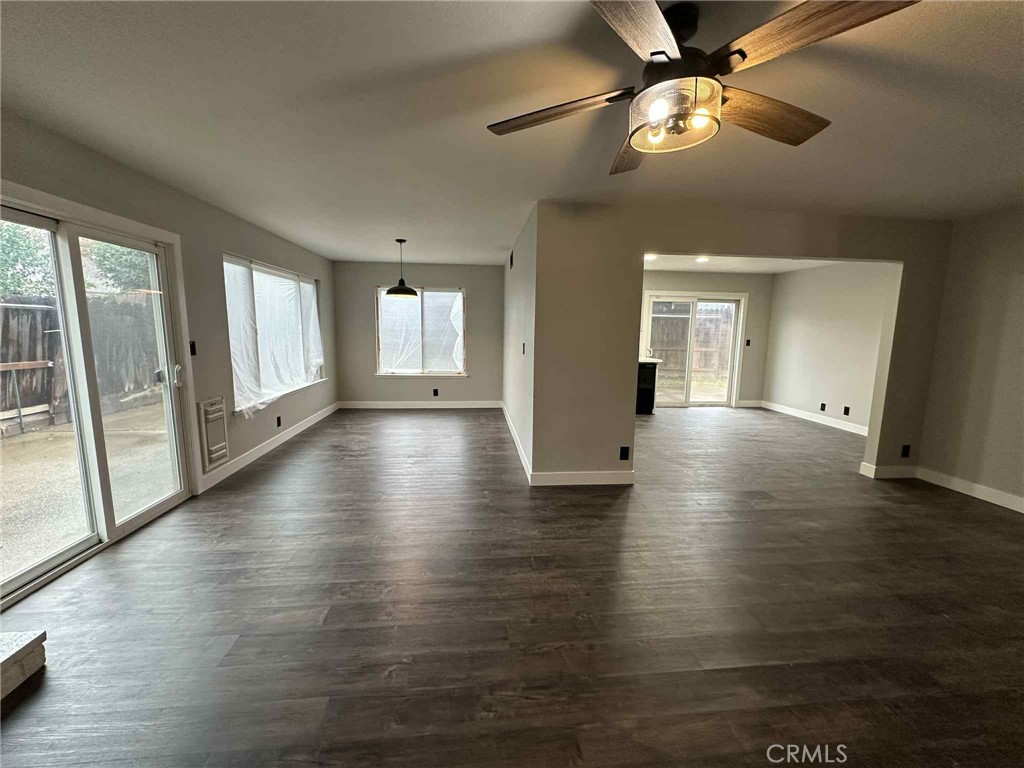 1939 Sierra Court Merced, CA 95340 - Photo 7 of 22 an empty room with wooden floor and windows