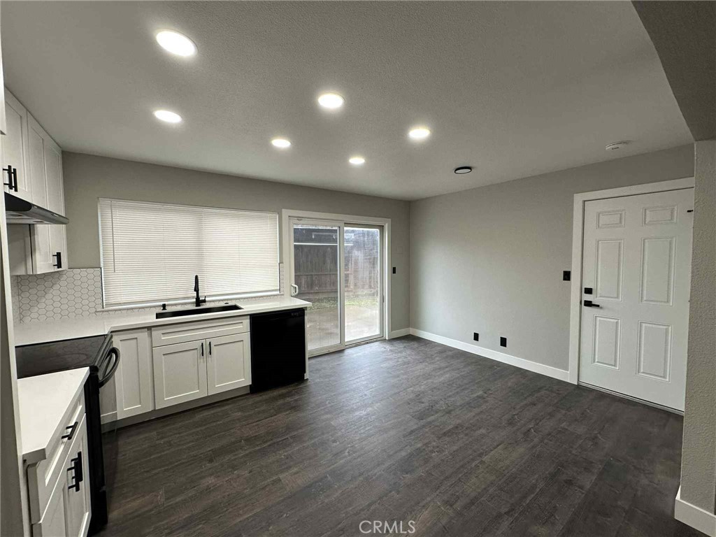 1939 Sierra Court Merced, CA 95340 - Photo 10 of 22 a large kitchen with stainless steel appliances granite countertop a large counter top and a wooden floors