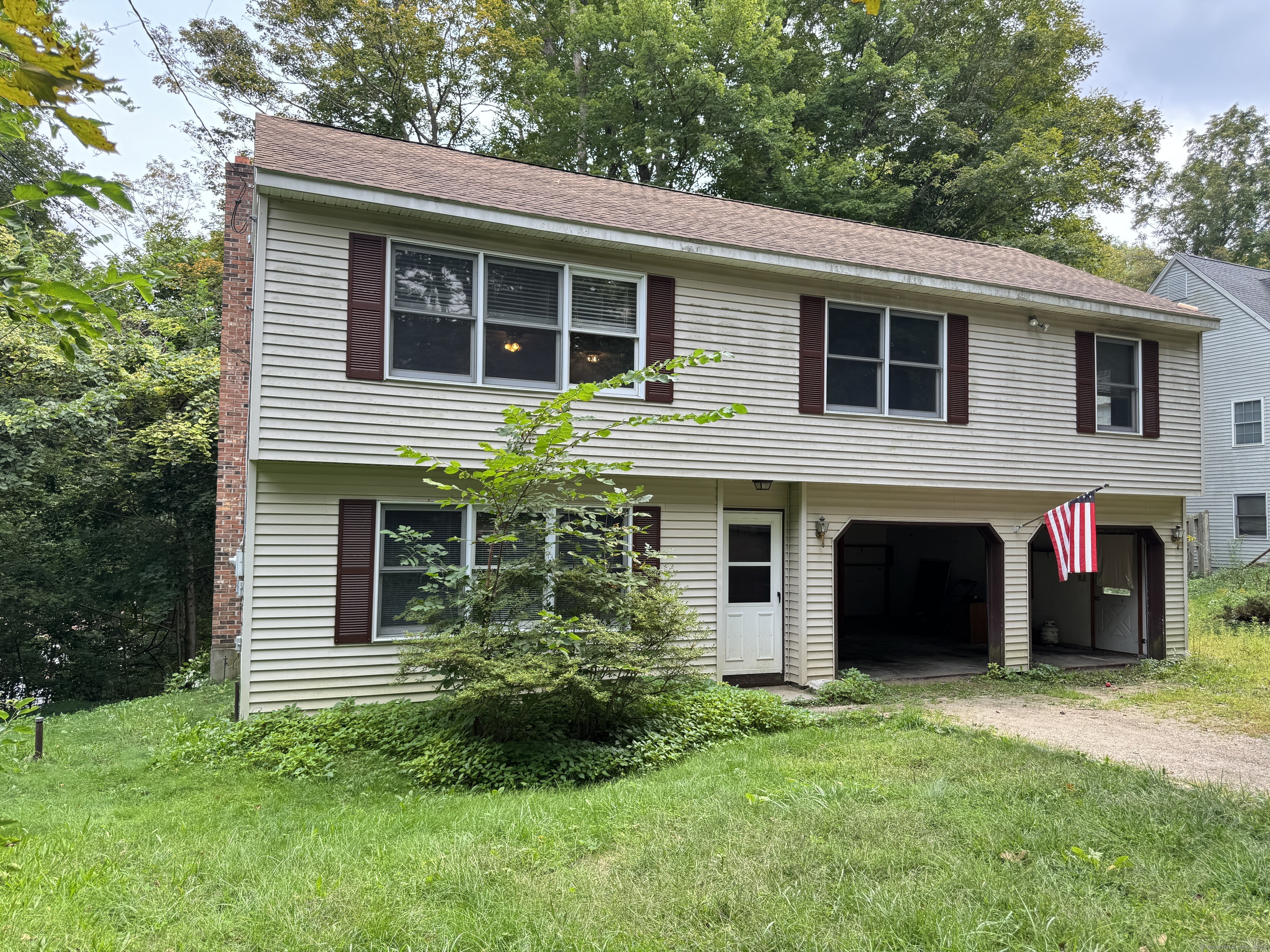 a view of a house with a yard and plants