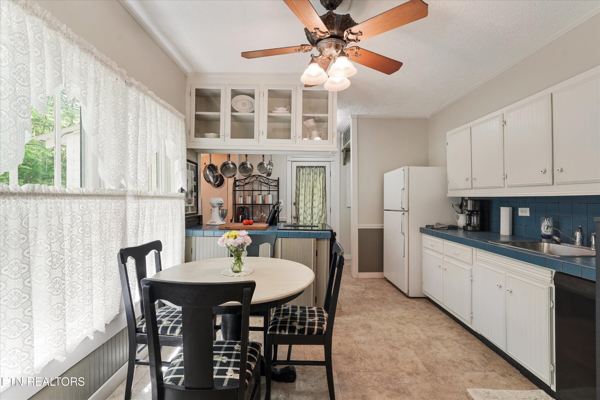 315 Laurel Hollow Road Clinton, TN 37716 - Photo 16 of 40 a kitchen with stainless steel appliances a dining table chairs and a refrigerator