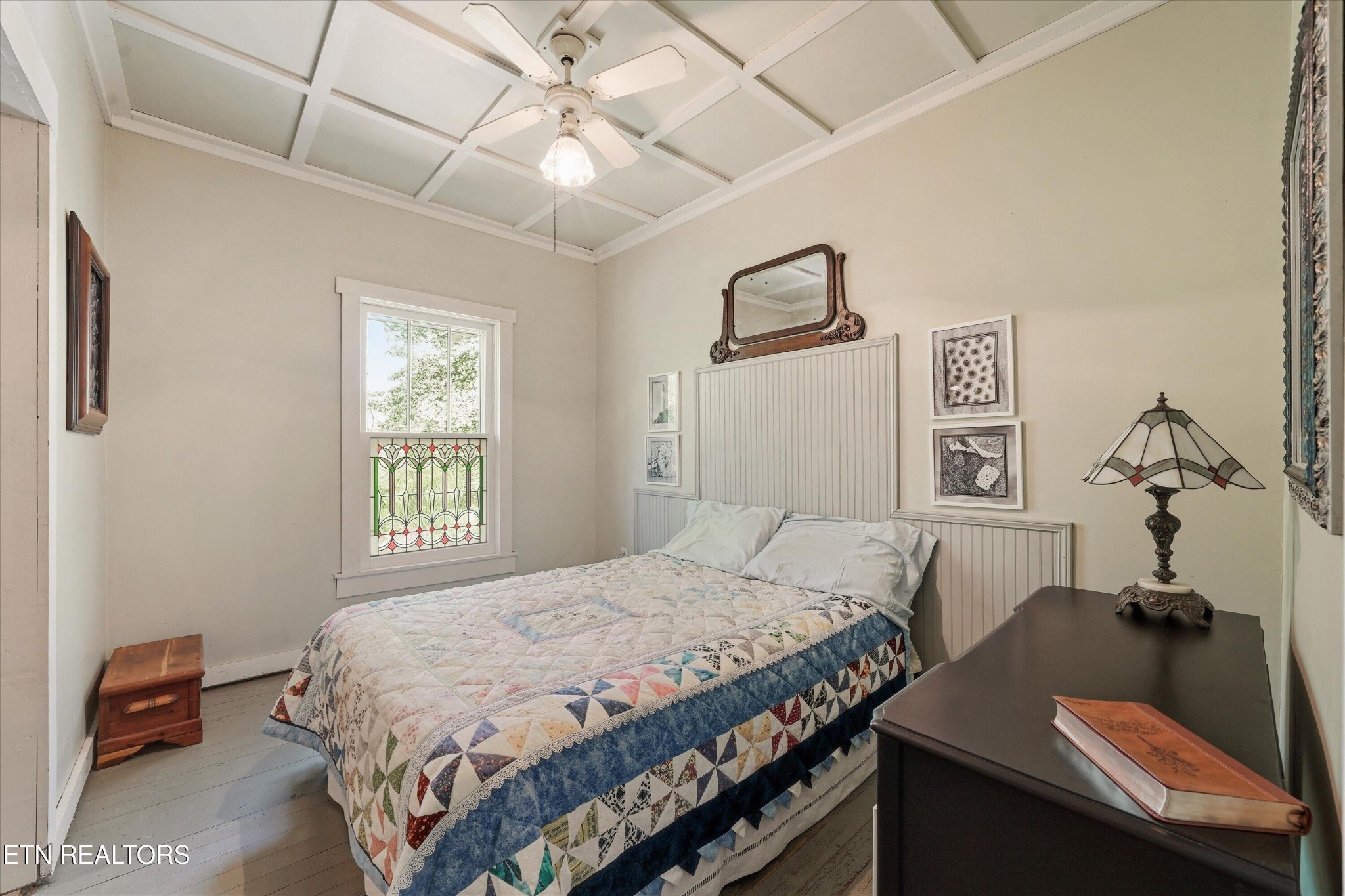 315 Laurel Hollow Road Clinton, TN 37716 - Photo 18 of 40 a bedroom with a bed and a chandelier