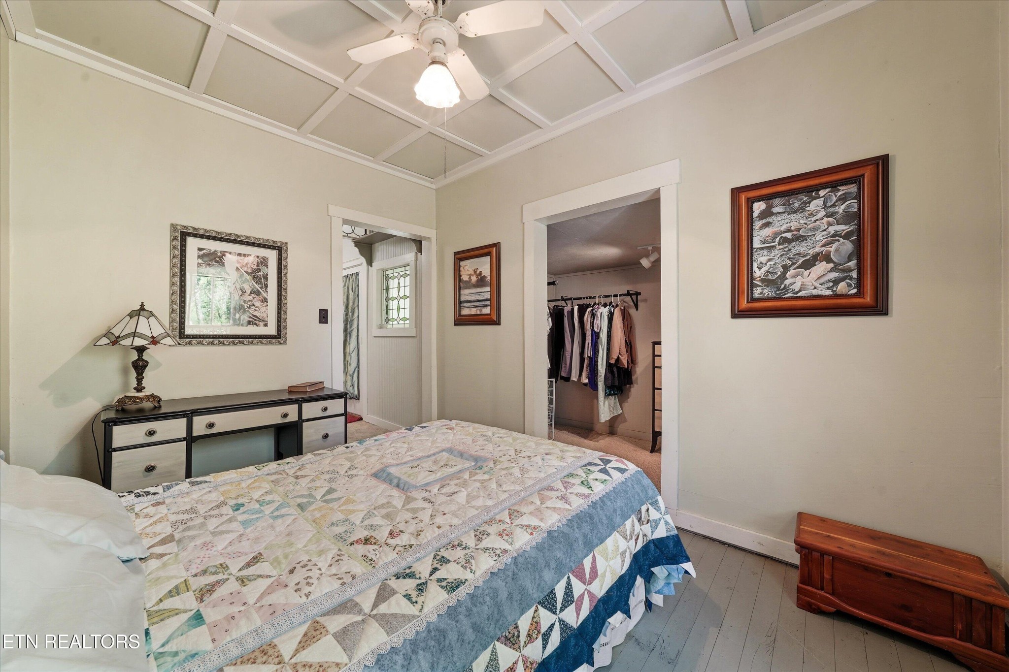 315 Laurel Hollow Road Clinton, TN 37716 - Photo 19 of 40 a bedroom with a bed and a chandelier