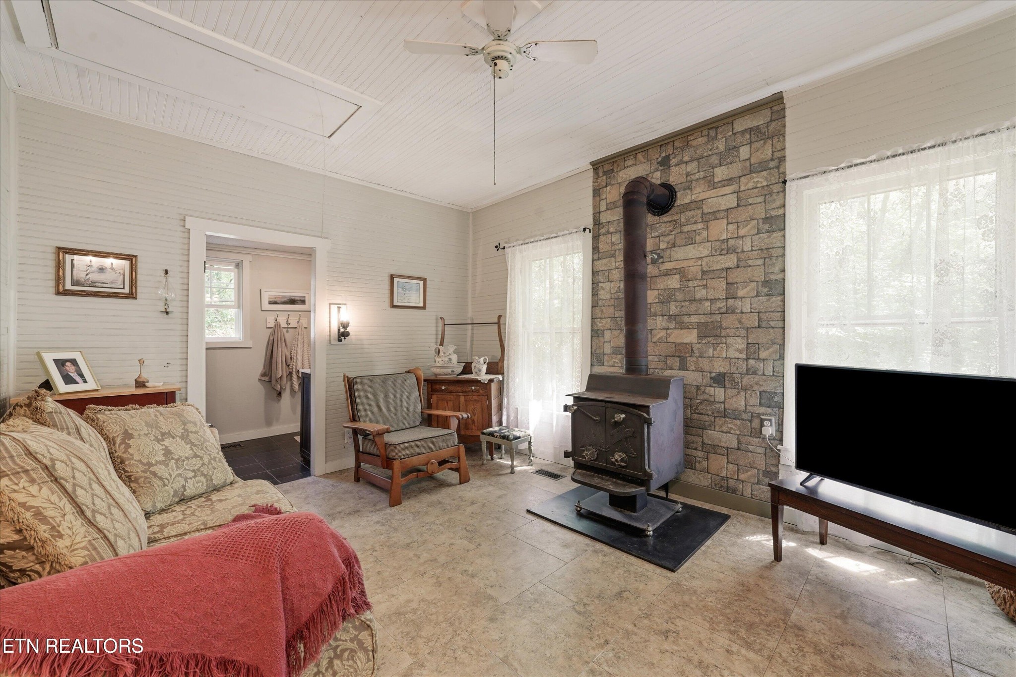 315 Laurel Hollow Road Clinton, TN 37716 - Photo 6 of 40 a living room with furniture a flat screen tv and a fireplace