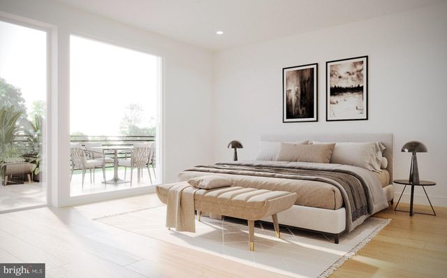 a bedroom with a bed and glass window