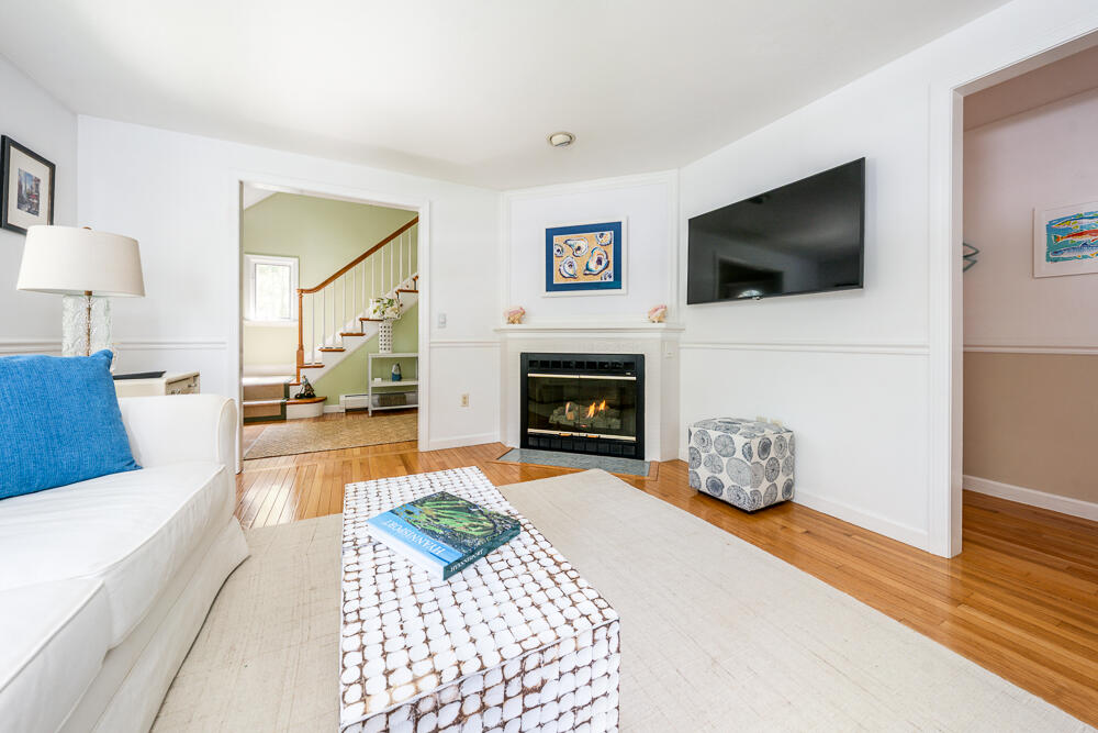 67 Spy Glass Hill Road Barnstable, MA 02675 - Photo 8 of 43 a living room with furniture a flat screen tv and a fireplace