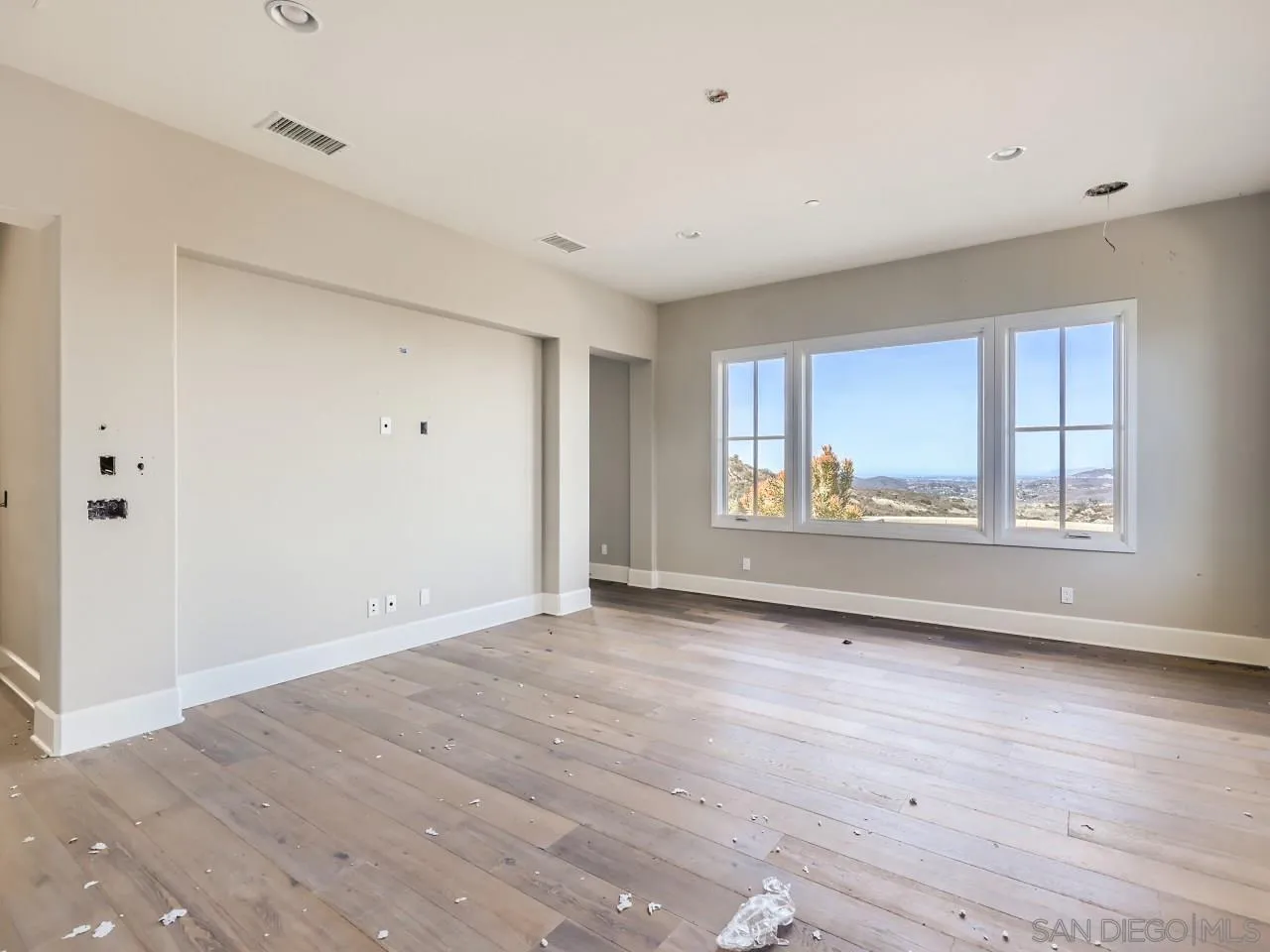 18214 Avenida Apice Escondido, CA 92029 - Photo 13 of 26 a view of an empty room with wooden floor and a window