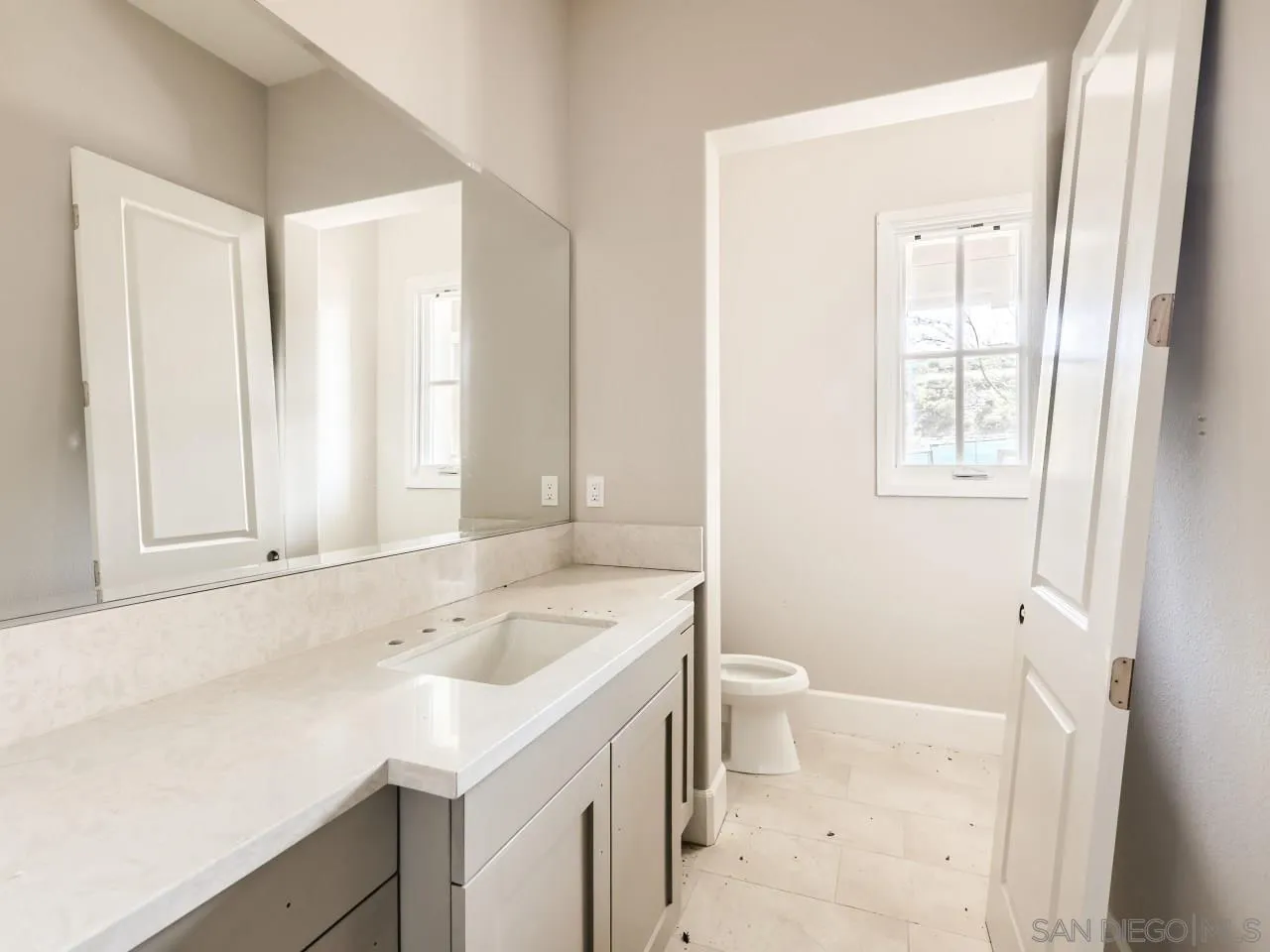18214 Avenida Apice Escondido, CA 92029 - Photo 19 of 26 a bathroom with a sink a toilet and a window
