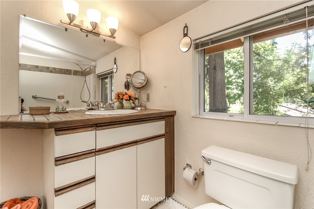 13005 Southeast 95th Way Renton, WA 98056 - Photo 22 of 40 a bathroom with a toilet sink and mirror