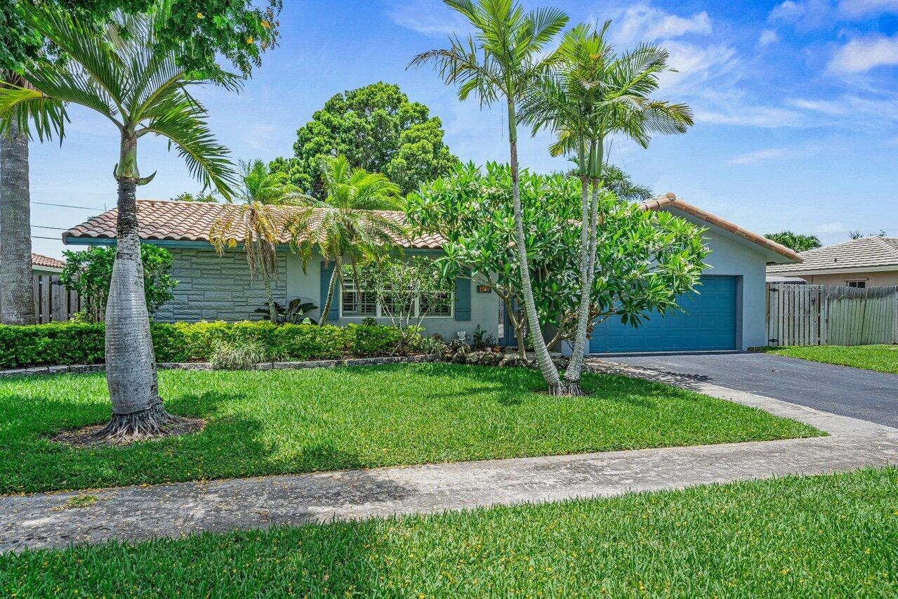 105 Orchard Ridge Lane Boca Raton, FL 33431 - Photo 27 of 37 a front view of a house with a garden and yard