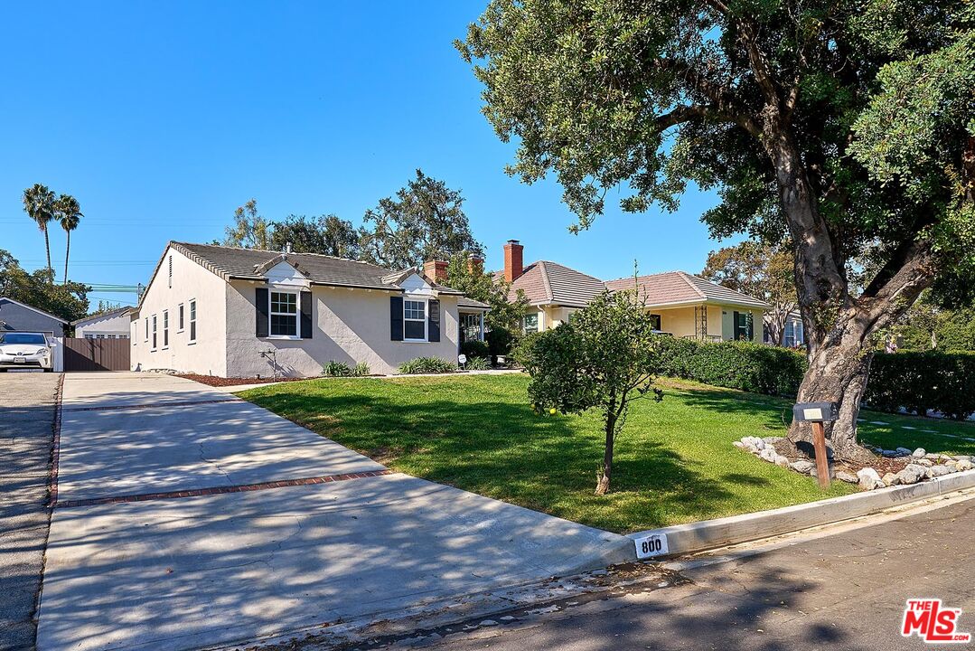 a view of a white house with a yard
