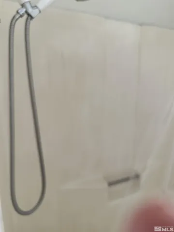 a bathroom with a sink a mirror and shower