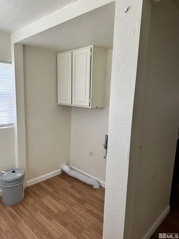 a view of small space with wooden floor and sink