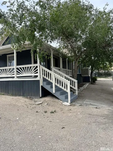 a view of a house with backyard and deck