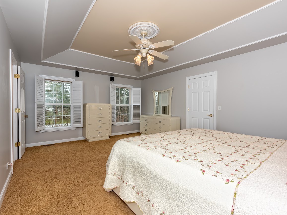 117 Grey Fox Court Streamwood, IL 60107 - Photo 13 of 31 a spacious bedroom with a bed and a chandelier