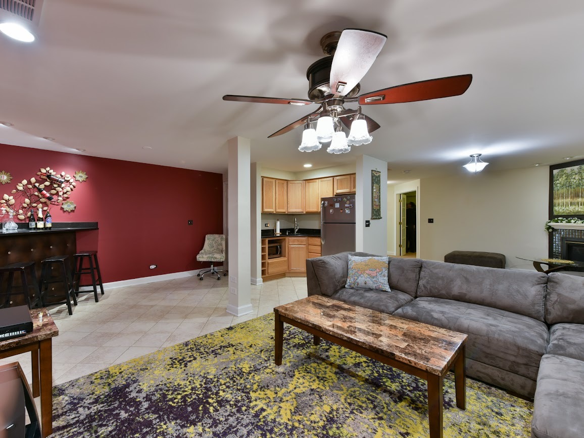 117 Grey Fox Court Streamwood, IL 60107 - Photo 25 of 31 a living room with furniture and a chandelier