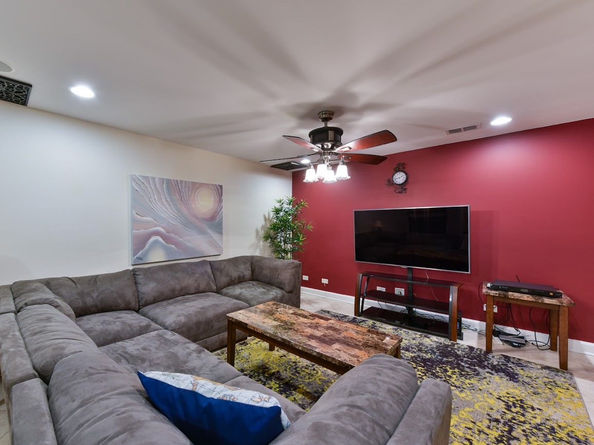117 Grey Fox Court Streamwood, IL 60107 - Photo 29 of 31 a living room with furniture and a flat screen tv