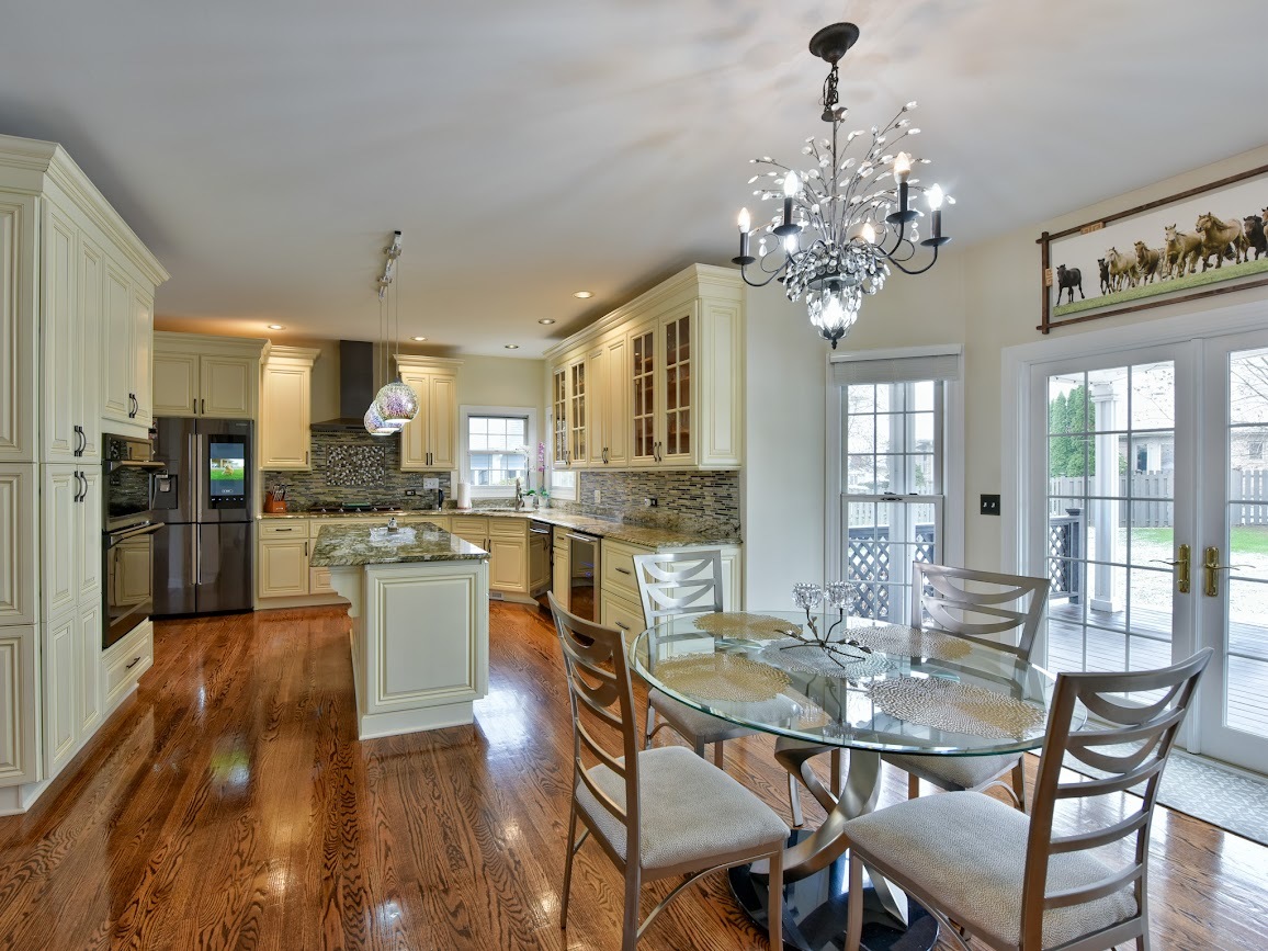 117 Grey Fox Court Streamwood, IL 60107 - Photo 6 of 31 a dining room filled chandelier and wooden floor