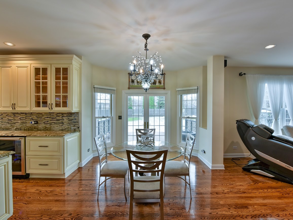 117 Grey Fox Court Streamwood, IL 60107 - Photo 7 of 31 a dining room with furniture wooden floor and a chandelier
