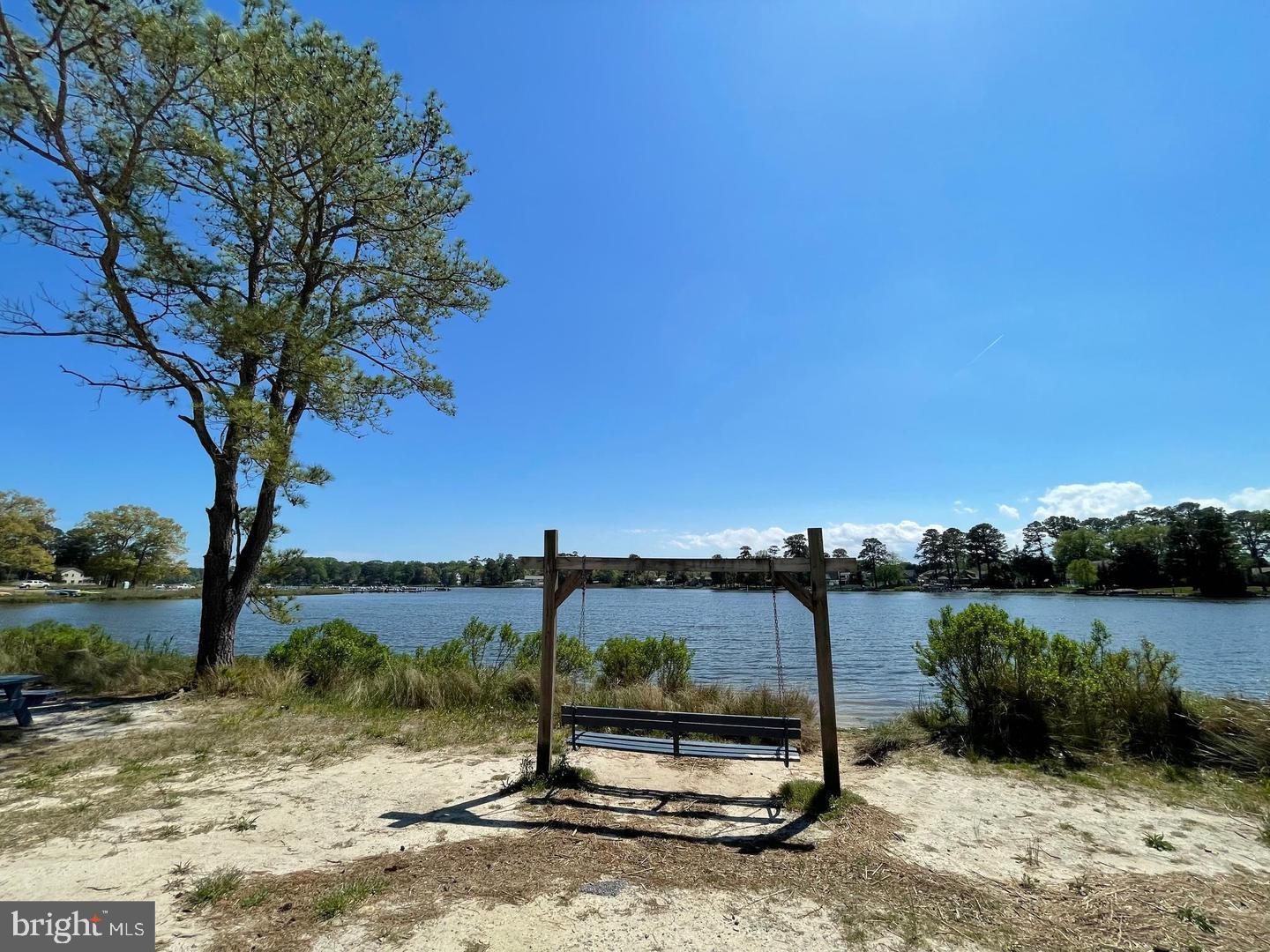 22887 Sycamore Drive Lewes, DE 19958 - Photo 18 of 38 a view of a lake with a yard