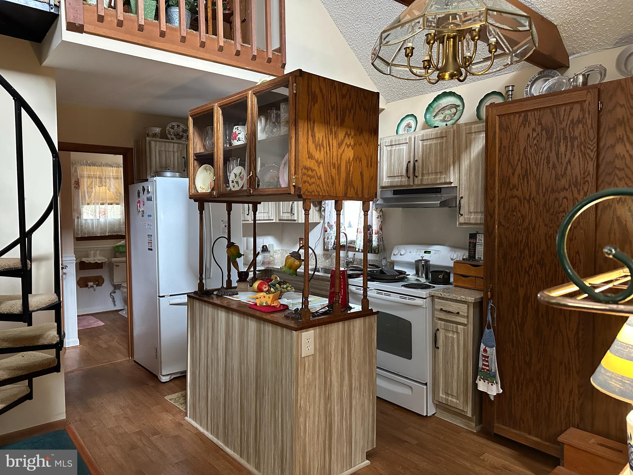 22887 Sycamore Drive Lewes, DE 19958 - Photo 3 of 38 a kitchen with stainless steel appliances granite countertop a stove and a refrigerator