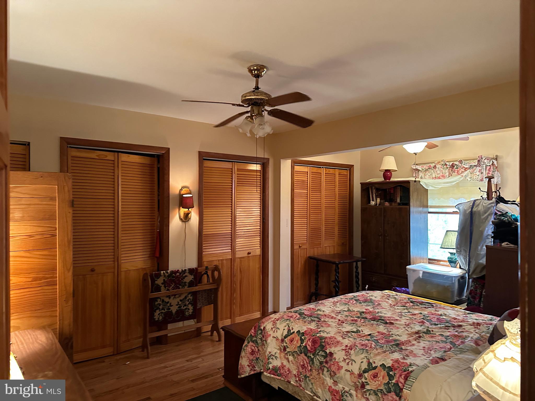 22887 Sycamore Drive Lewes, DE 19958 - Photo 37 of 38 a bedroom with a bed and a chandelier