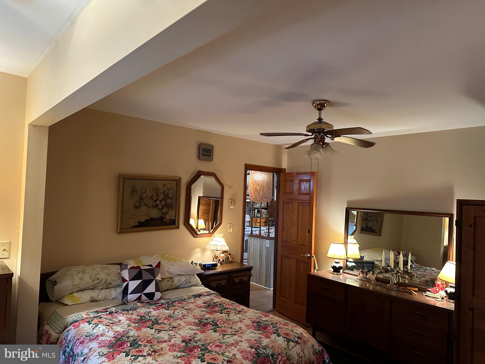 22887 Sycamore Drive Lewes, DE 19958 - Photo 38 of 38 a bedroom with a bed a mirror on the wall and dresser