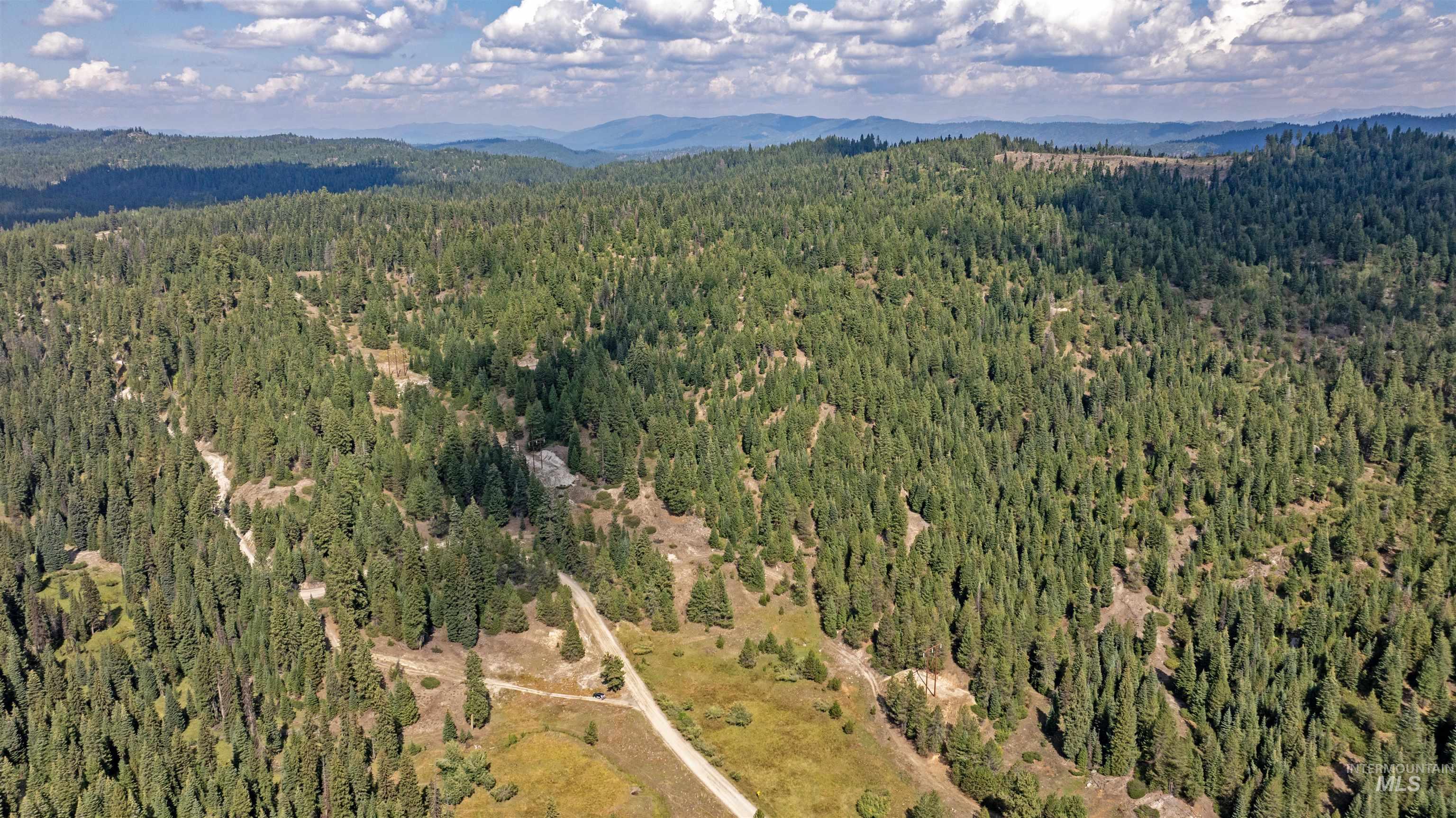 1 High Valley Road Cascade, ID 83611 - Photo 6 of 13 Bird's eye view of a heavily wooded area and a mountain backdrop
