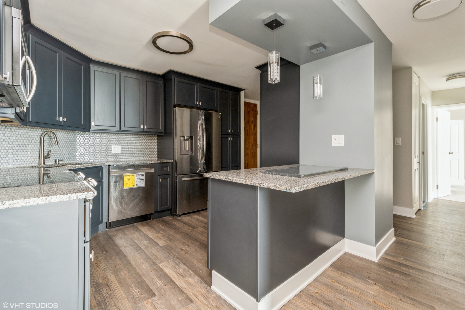 6033 North Sheridan Road, Unit 43D Chicago, IL 60660 - Photo 3 of 16 a kitchen with cabinets and wooden floor