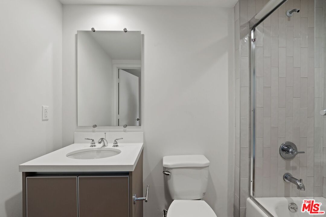 130 South Croft Avenue, Unit 201 Los Angeles, CA 90048 - Photo 13 of 14 a bathroom with a sink toilet and shower