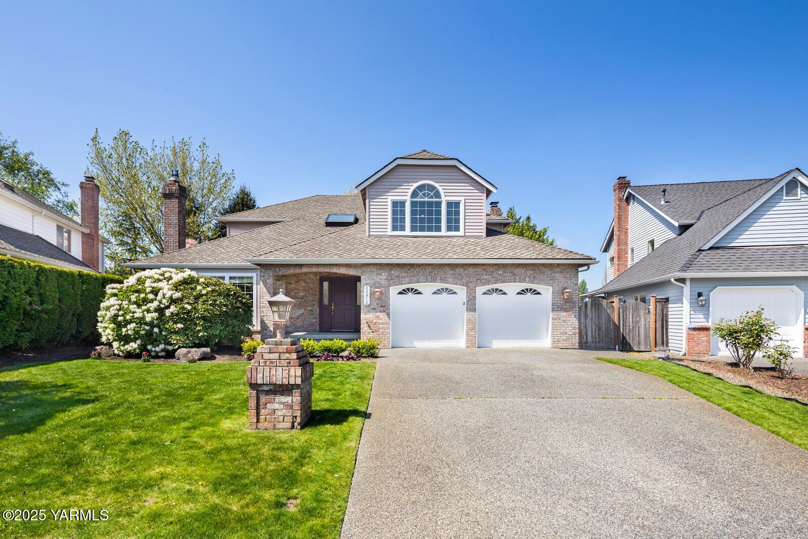 23812 21st Drive Southeast, Unit SE Bothell, WA 98021 - Photo 2 of 37 a front view of a house with a yard and outdoor seating