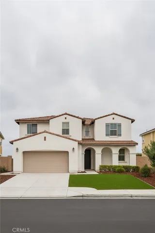a view of white house with a big yard and large trees