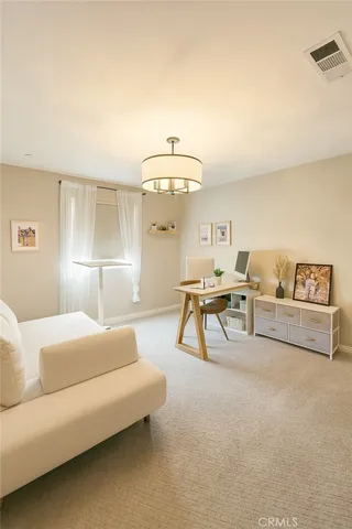 a living room with furniture and a lamp