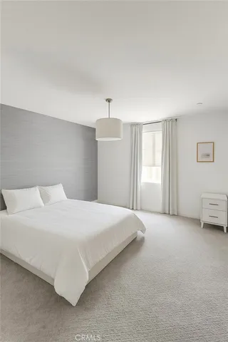 a bedroom with a bed and a cabinets