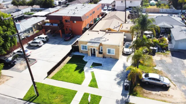 an aerial view of multiple houses with yard
