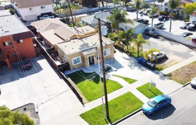 a view of a patio with table and chairs potted plants